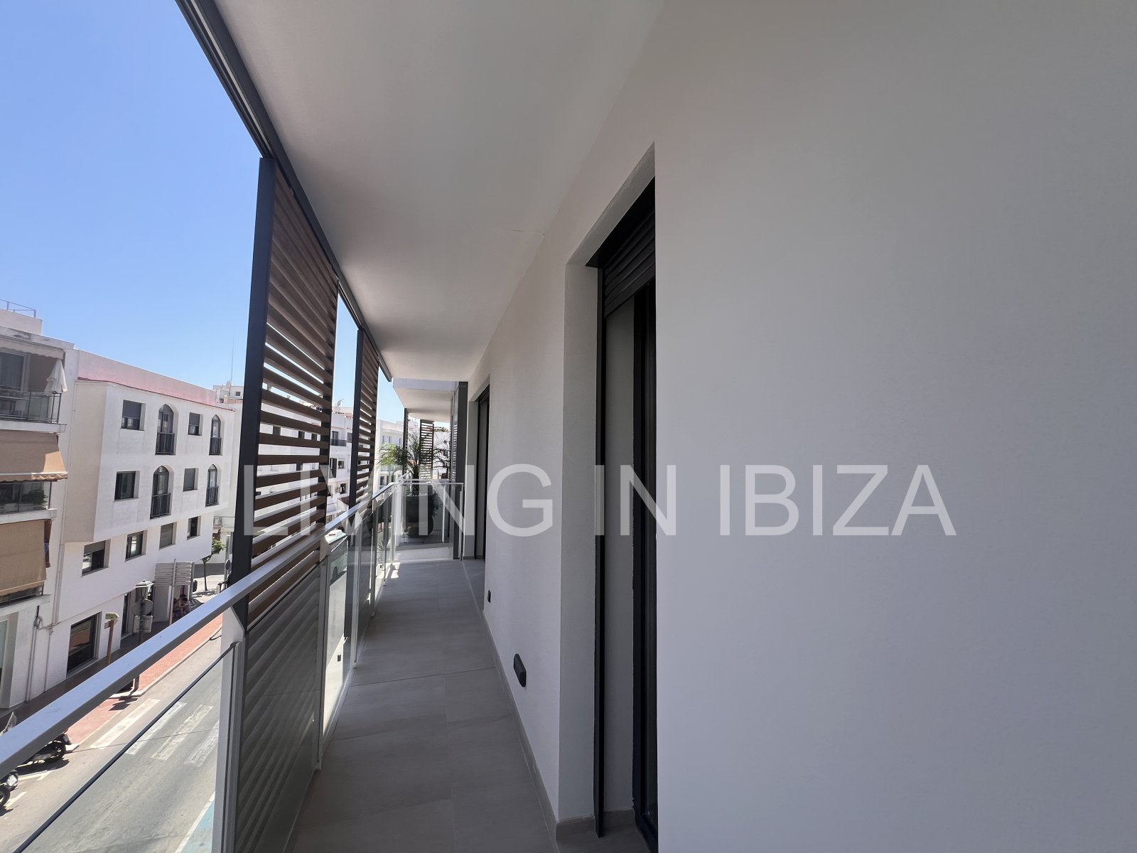 Annual rental. Available 15th July. Attractive and modern new unfurnished flat, with communal pool, parking, in Santa Eulalia, Ibiza.