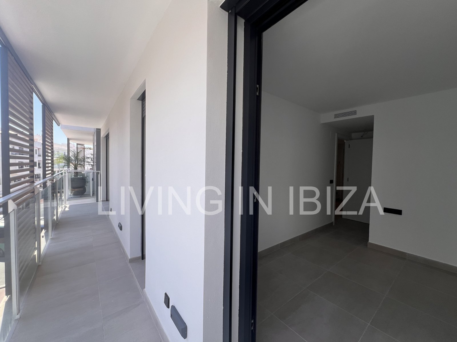 Annual rental. Available 15th July. Attractive and modern new unfurnished flat, with communal pool, parking, in Santa Eulalia, Ibiza.