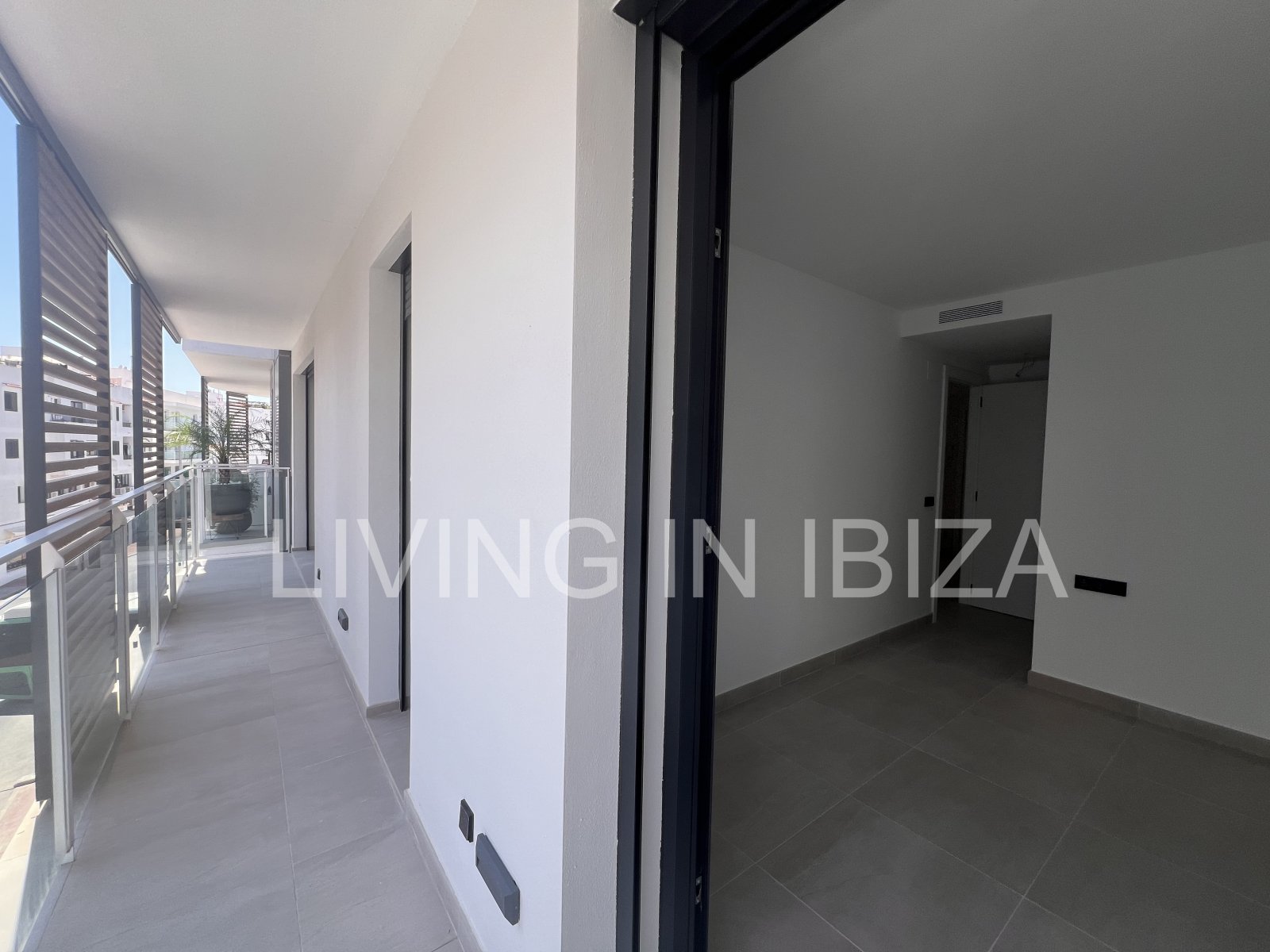 Annual rental. Available 15th July. Attractive and modern new unfurnished flat, with communal pool, parking, in Santa Eulalia, Ibiza.