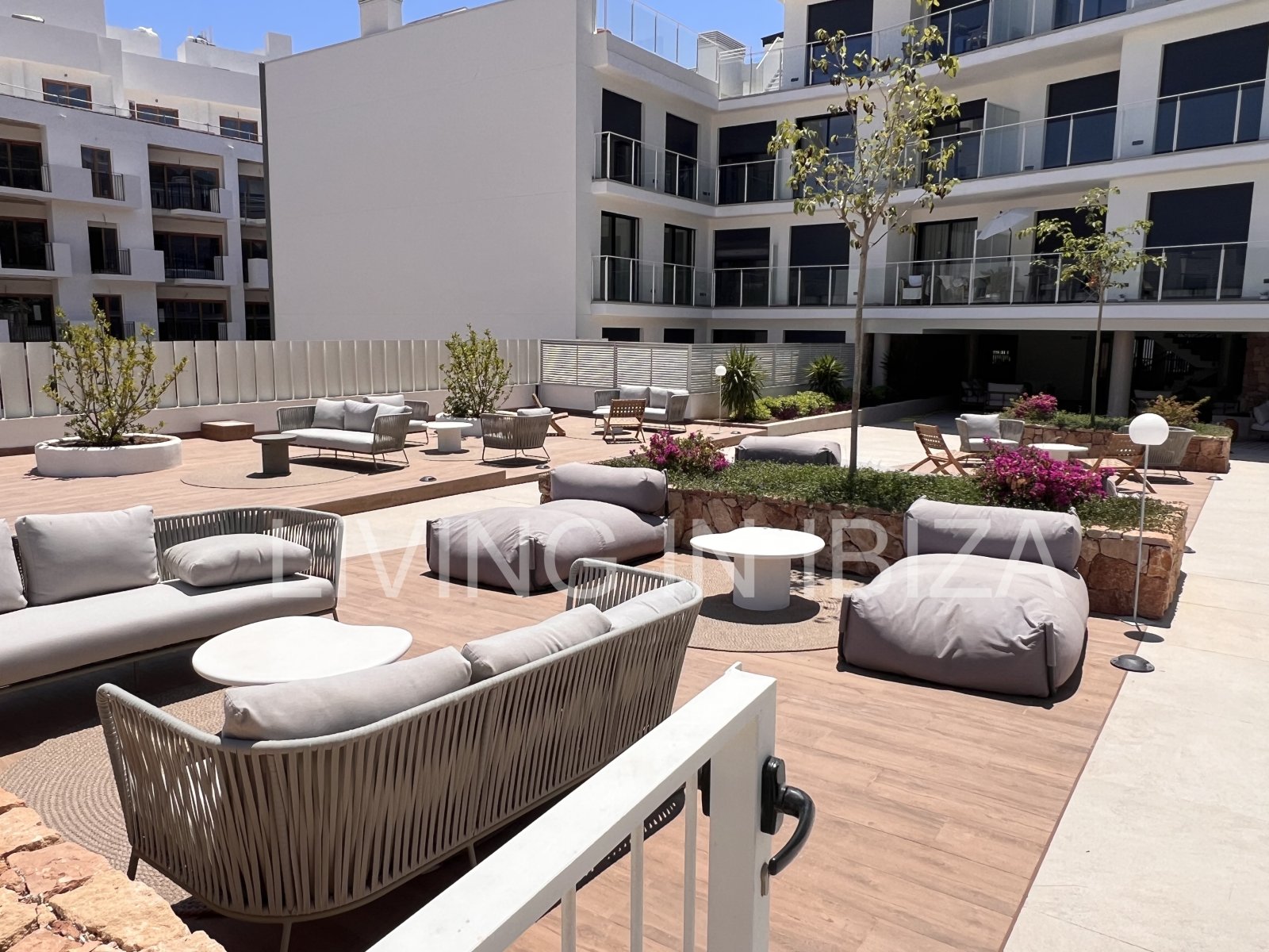 Annual rental. Available 15th July. Attractive and modern new unfurnished flat, with communal pool, parking, in Santa Eulalia, Ibiza.