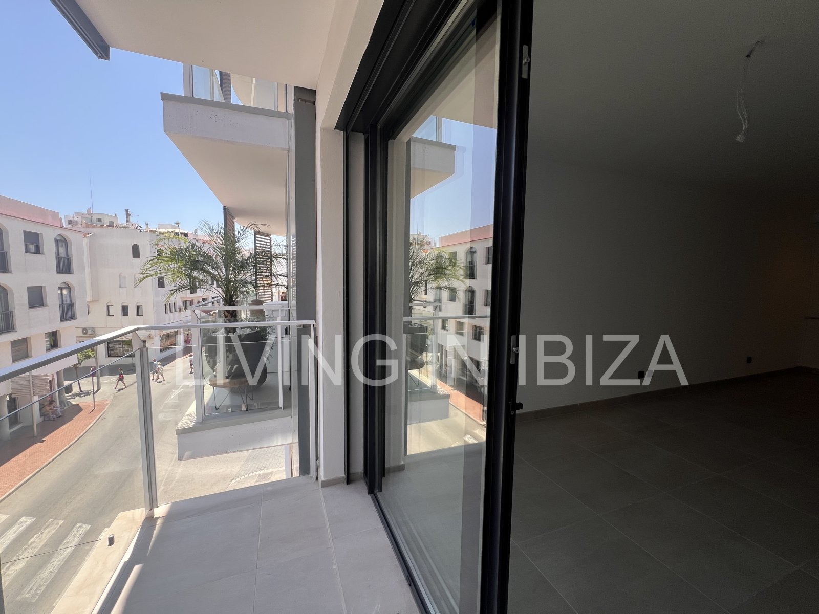 Annual rental. Available 15th July. Attractive and modern new unfurnished flat, with communal pool, parking, in Santa Eulalia, Ibiza.