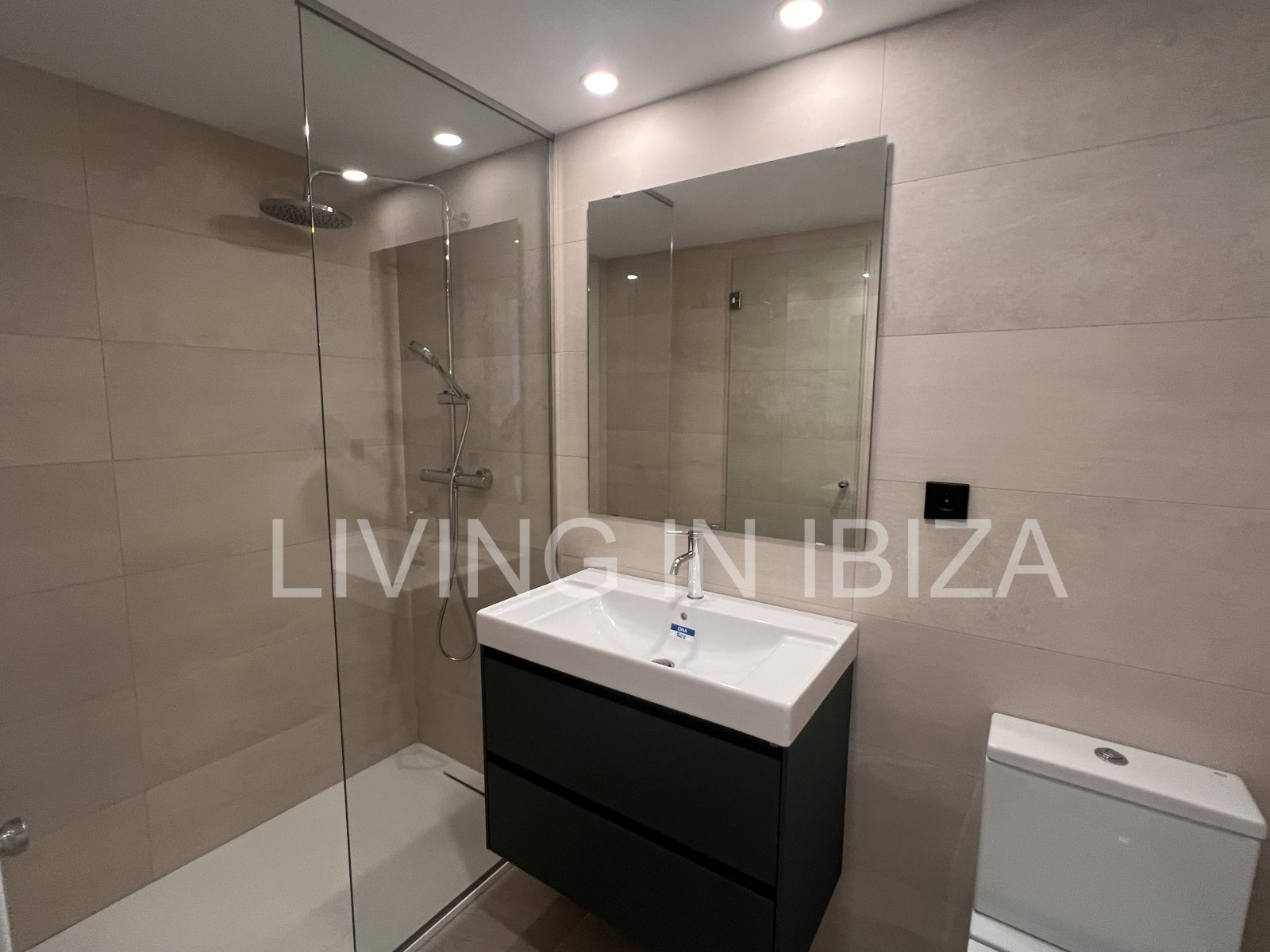 Annual rental. Available 15th July. Attractive and modern new unfurnished flat, with communal pool, parking, in Santa Eulalia, Ibiza.