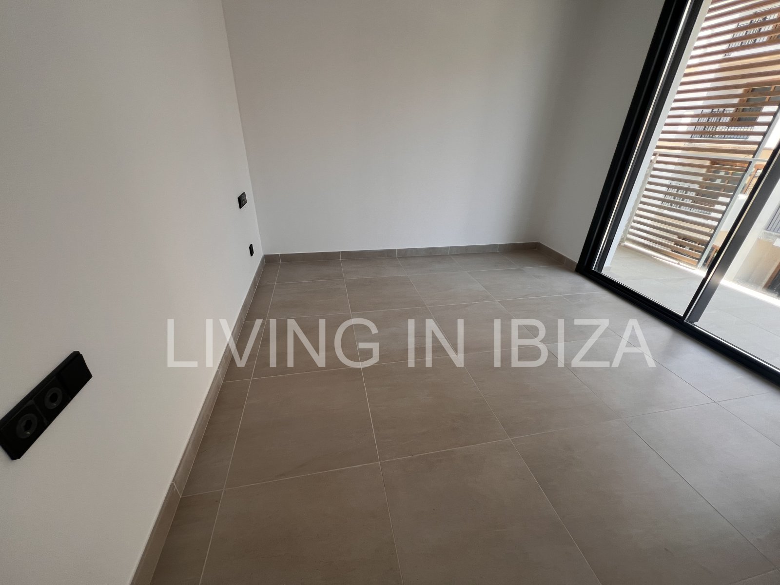 Annual rental. Available 15th July. Attractive and modern new unfurnished flat, with communal pool, parking, in Santa Eulalia, Ibiza.