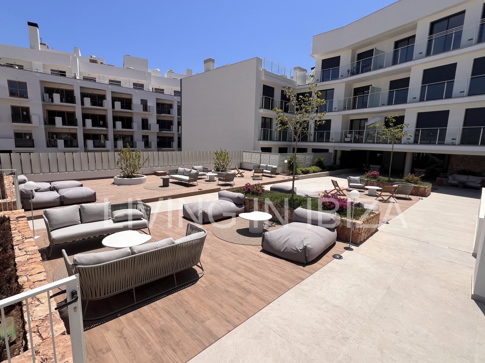 Annual rental. Available 15th July. Attractive and modern new unfurnished flat, with communal pool, parking, in Santa Eulalia, Ibiza.