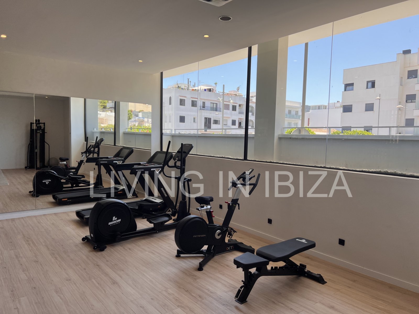 Annual rental. Available 15th July. Attractive and modern new unfurnished flat, with communal pool, parking, in Santa Eulalia, Ibiza.