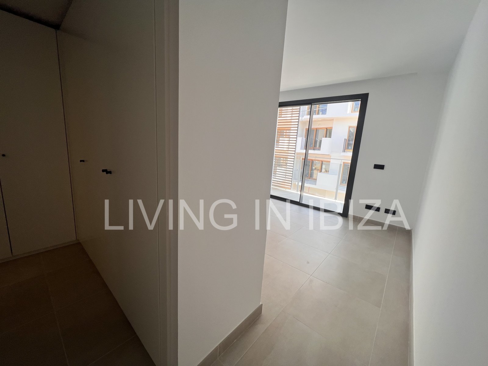 Annual rental. Available 15th July. Attractive and modern new unfurnished flat, with communal pool, parking, in Santa Eulalia, Ibiza.