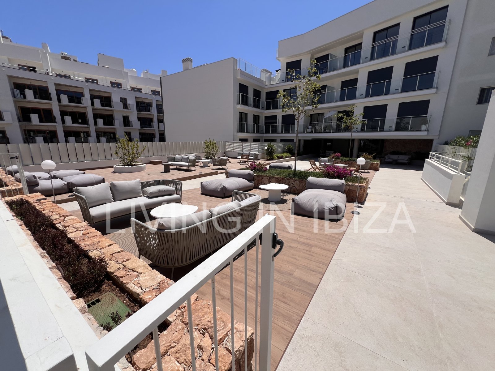Annual rental. Available 15th July. Attractive and modern new unfurnished flat, with communal pool, parking, in Santa Eulalia, Ibiza.