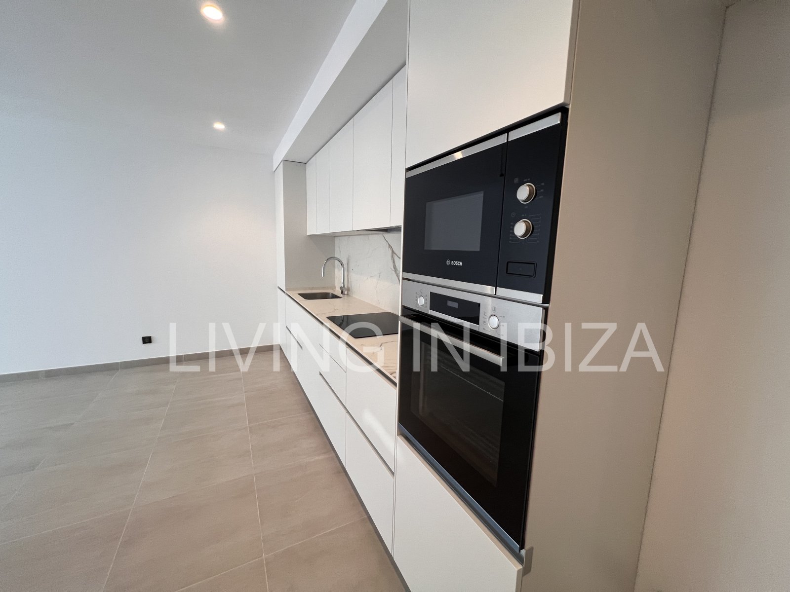 Annual rental. Available 15th July. Attractive and modern new unfurnished flat, with communal pool, parking, in Santa Eulalia, Ibiza.