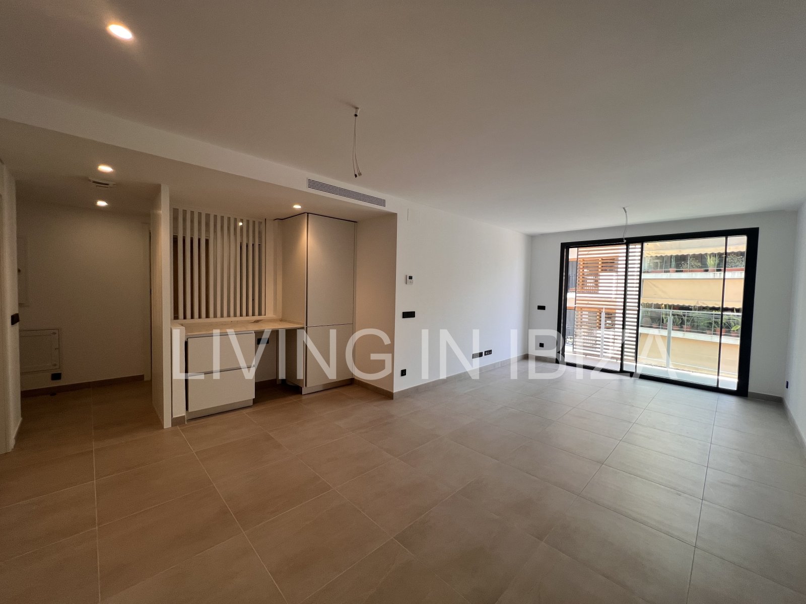 Annual rental. Available 15th July. Attractive and modern new unfurnished flat, with communal pool, parking, in Santa Eulalia, Ibiza.