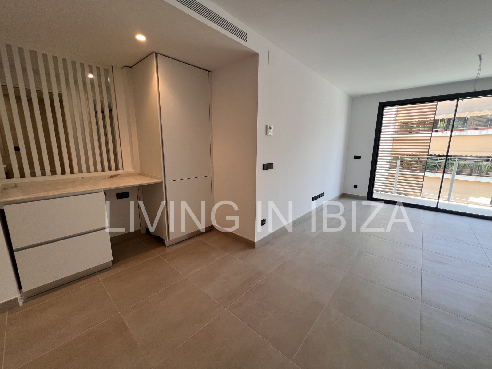 Annual rental. Available 15th July. Attractive and modern new unfurnished flat, with communal pool, parking, in Santa Eulalia, Ibiza.
