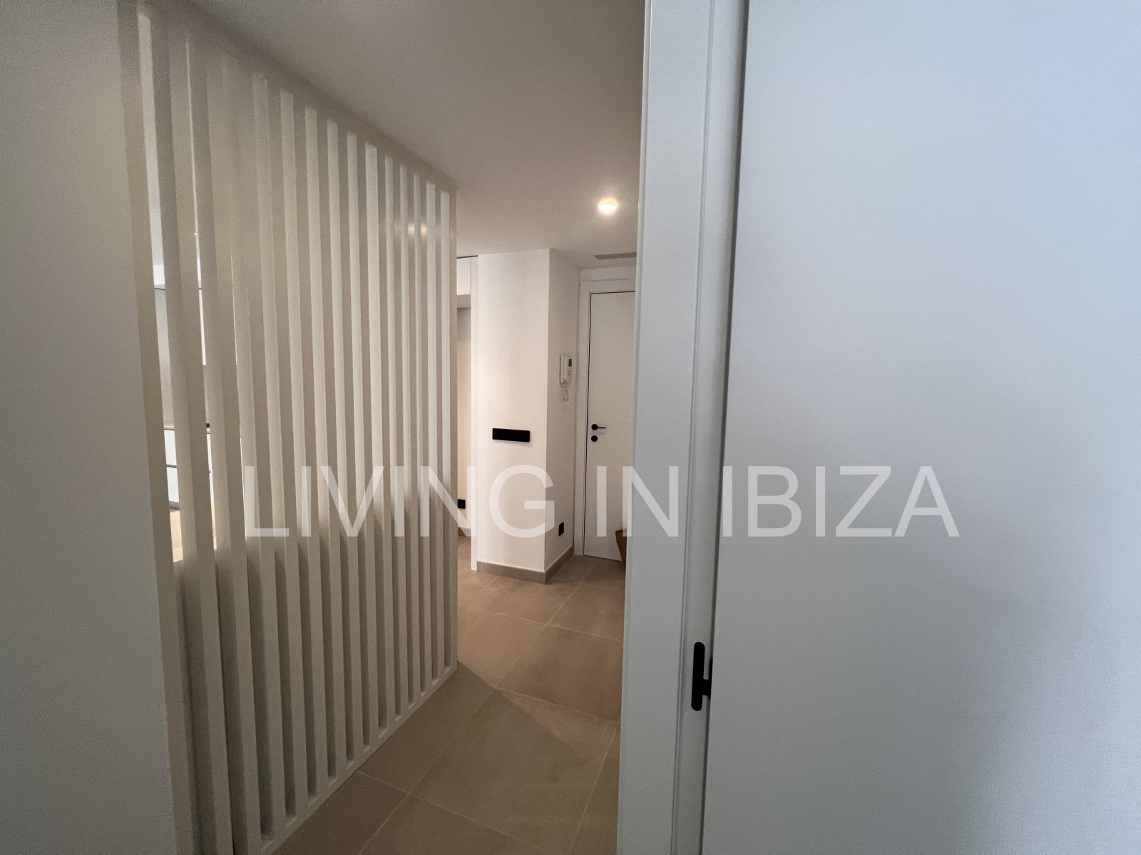 Annual rental. Available 15th July. Attractive and modern new unfurnished flat, with communal pool, parking, in Santa Eulalia, Ibiza.