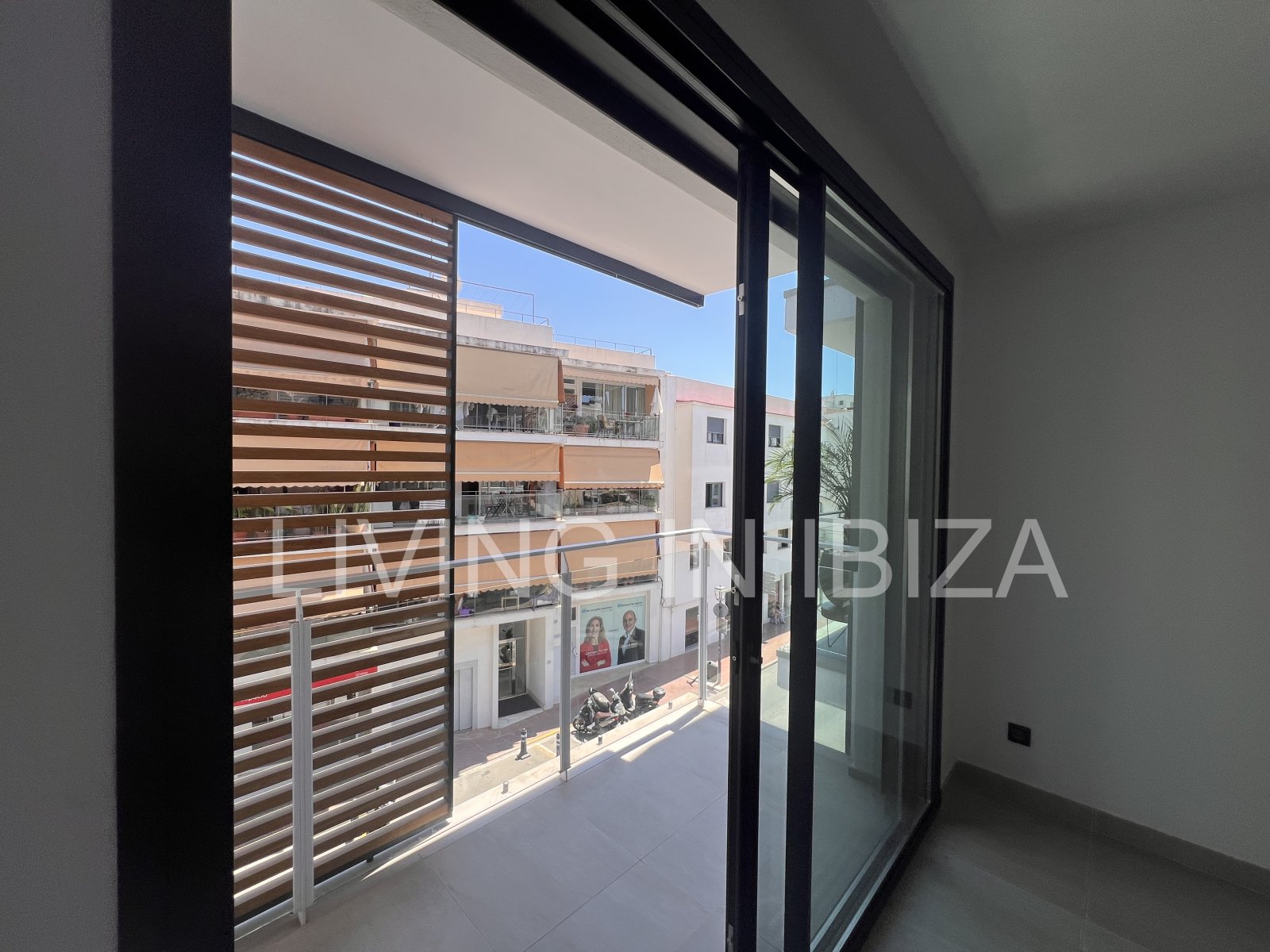 Annual rental. Available 15th July. Attractive and modern new unfurnished flat, with communal pool, parking, in Santa Eulalia, Ibiza.