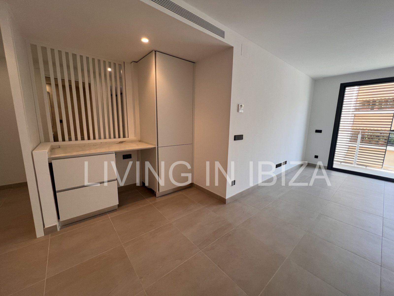 Annual rental. Available 15th July. Attractive and modern new unfurnished flat, with communal pool, parking, in Santa Eulalia, Ibiza.
