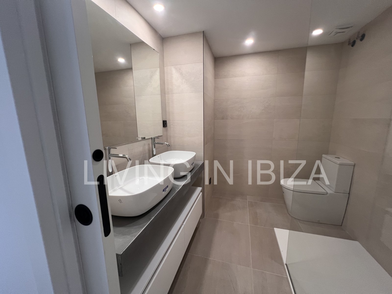 Annual rental. Available 15th July. Attractive and modern new unfurnished flat, with communal pool, parking, in Santa Eulalia, Ibiza.