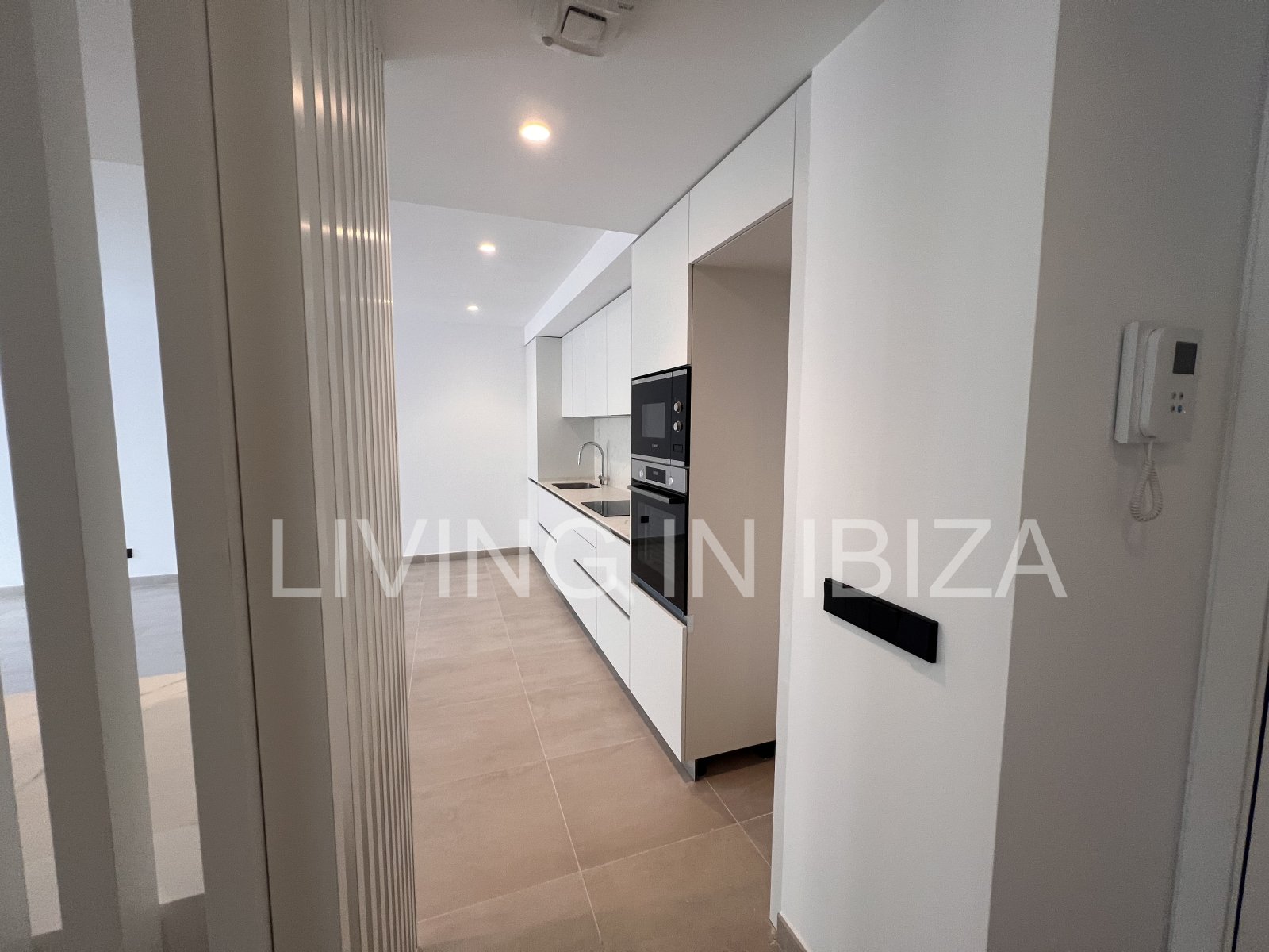 Annual rental. Available 15th July. Attractive and modern new unfurnished flat, with communal pool, parking, in Santa Eulalia, Ibiza.