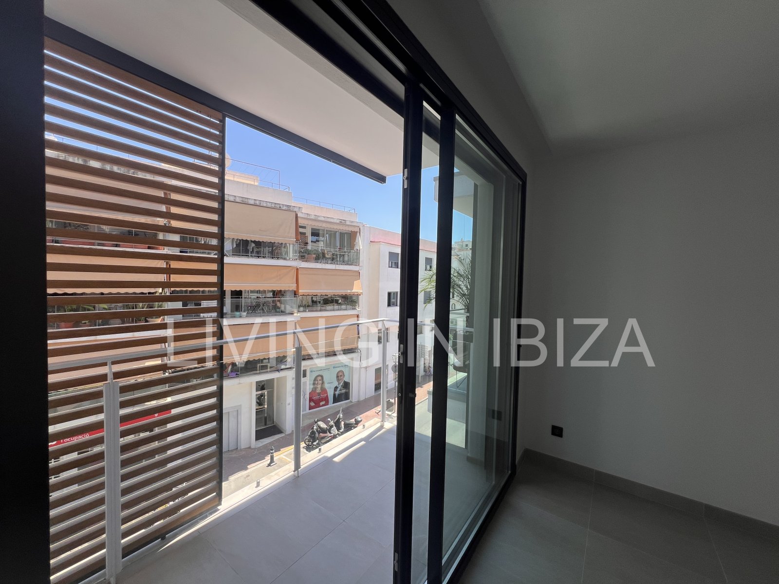 Annual rental. Available 15th July. Attractive and modern new unfurnished flat, with communal pool, parking, in Santa Eulalia, Ibiza.