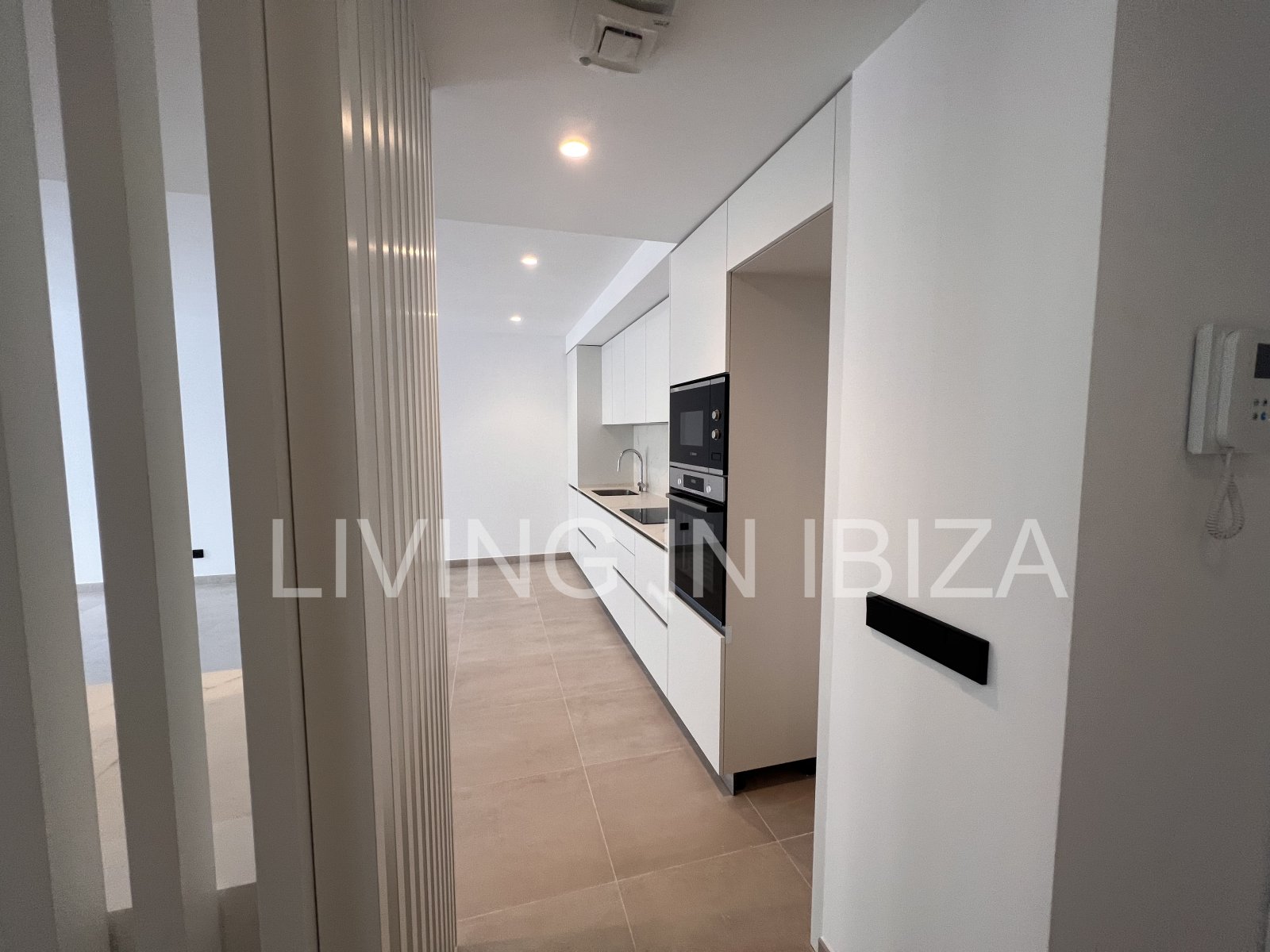 Annual rental. Available 15th July. Attractive and modern new unfurnished flat, with communal pool, parking, in Santa Eulalia, Ibiza.