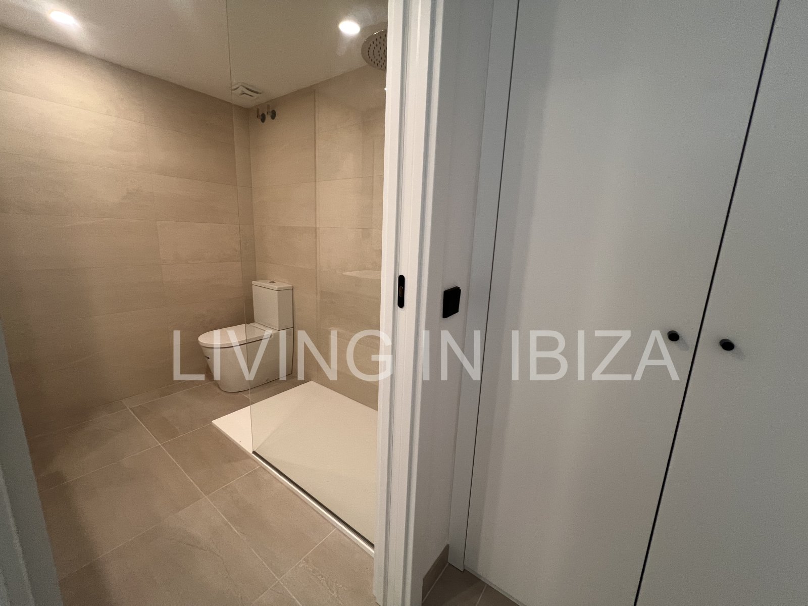 Annual rental. Available 15th July. Attractive and modern new unfurnished flat, with communal pool, parking, in Santa Eulalia, Ibiza.