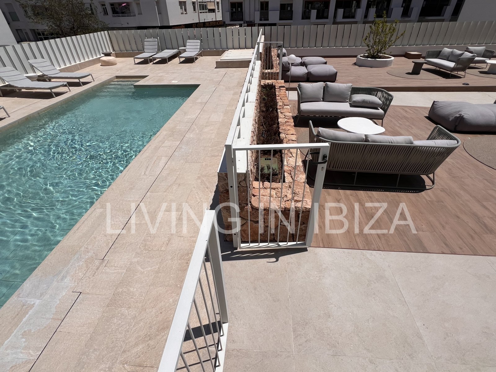 Annual rental. Available 15th July. Attractive and modern new unfurnished flat, with communal pool, parking, in Santa Eulalia, Ibiza.