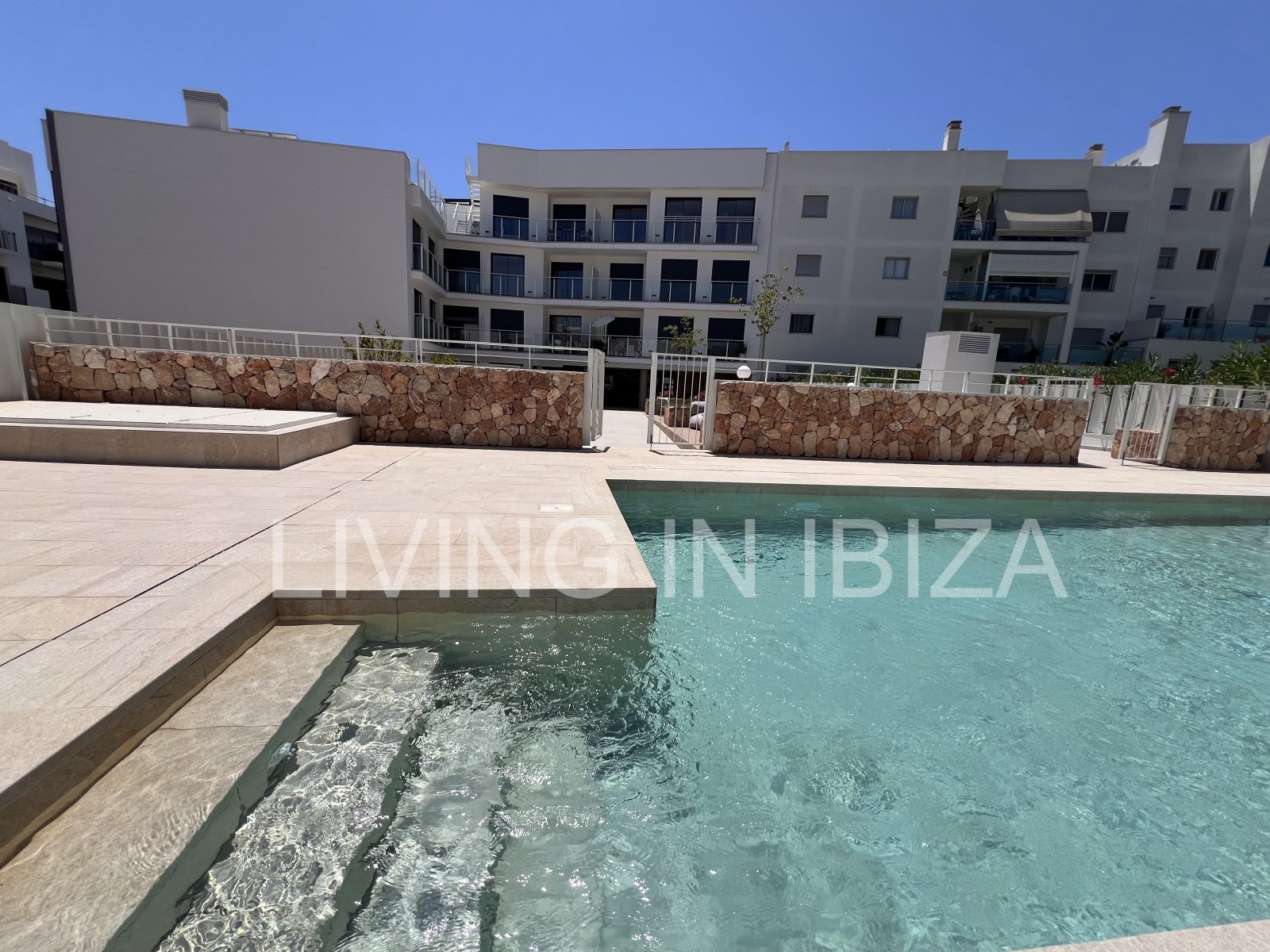Annual rental. Available 15th July. Attractive and modern new unfurnished flat, with communal pool, parking, in Santa Eulalia, Ibiza.