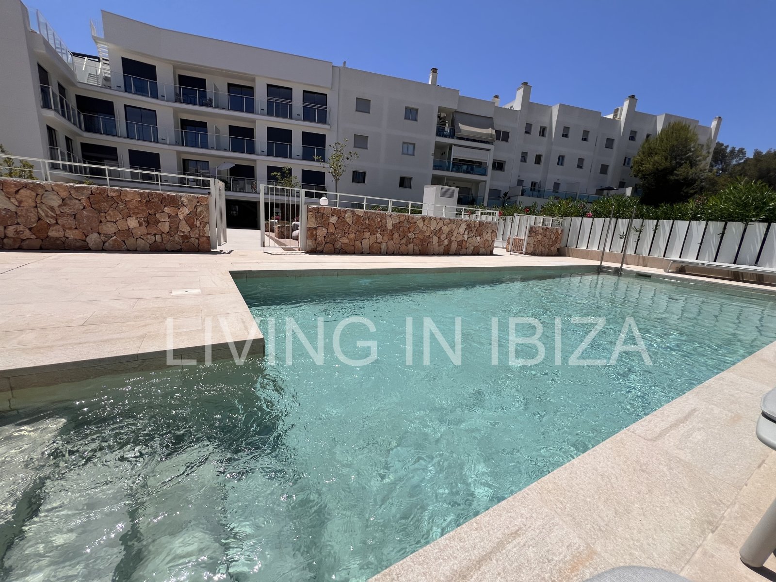 Annual rental. Available 15th July. Attractive and modern new unfurnished flat, with communal pool, parking, in Santa Eulalia, Ibiza.