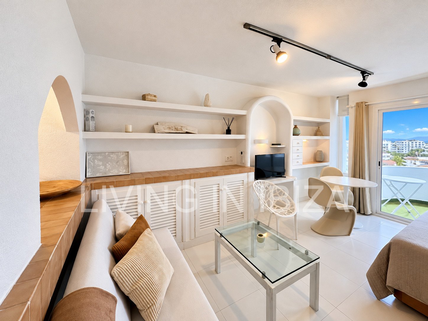 Seasonal temporary rental, cozy studio apartment with sea views on first line on promenade of Santa Eulalia del Rio, Ibiza.